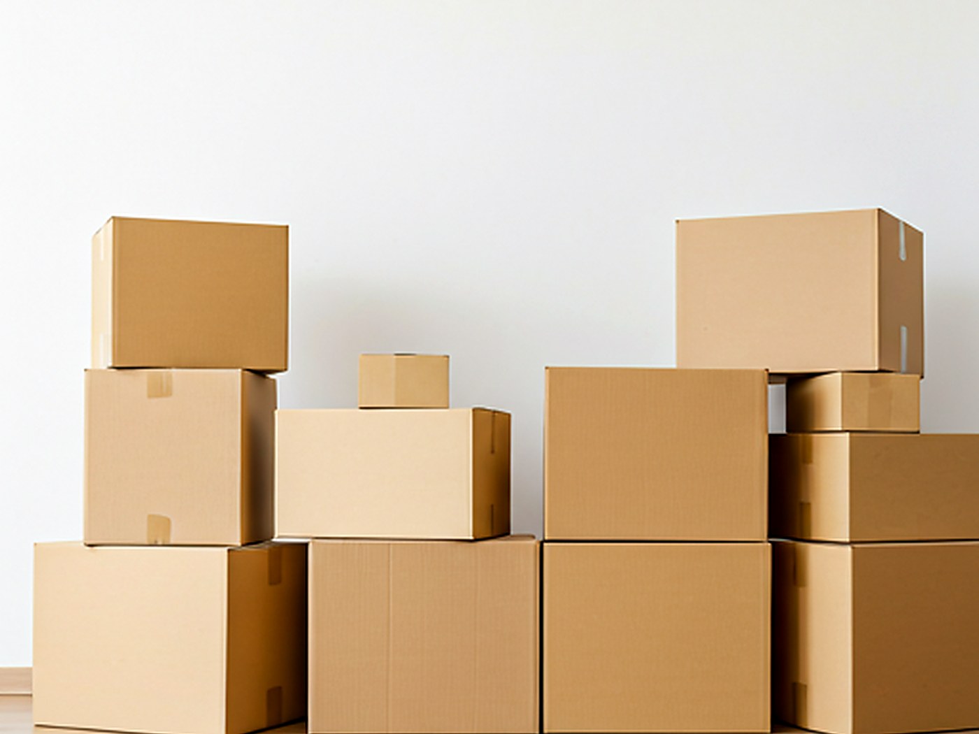 A bright modern living room with moving boxes neatly stacked, symbolizing a stress-free move